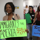 Anne Pierre (C) joins with other activists in front of the office of Sen. Bill Nelson (D-FL) to ask him to help recipients of the Deferred Action for Childhood Arrivals (DACA) as well as all immigrants living in America on February 2, 2018 in West Palm Beach, Florida.